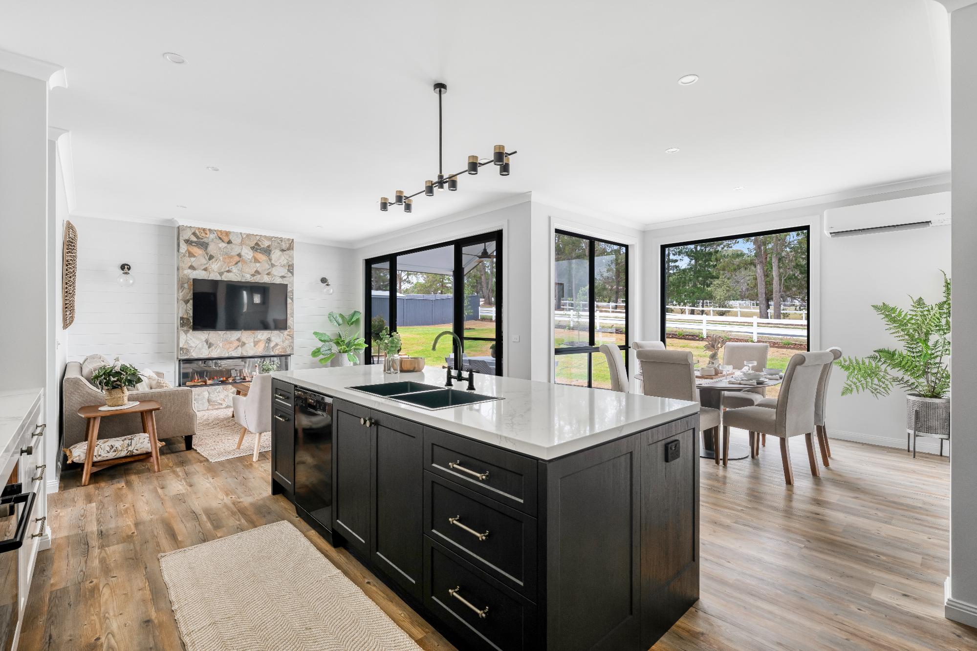 Open-plan American style home interior by Hotondo Homes with modern kitchen, living room and dining area