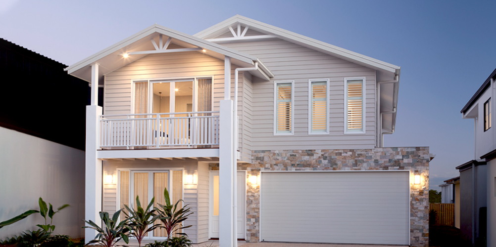 Double-storey American style house design by Hotondo Homes with weatherboard cladding and stone features
